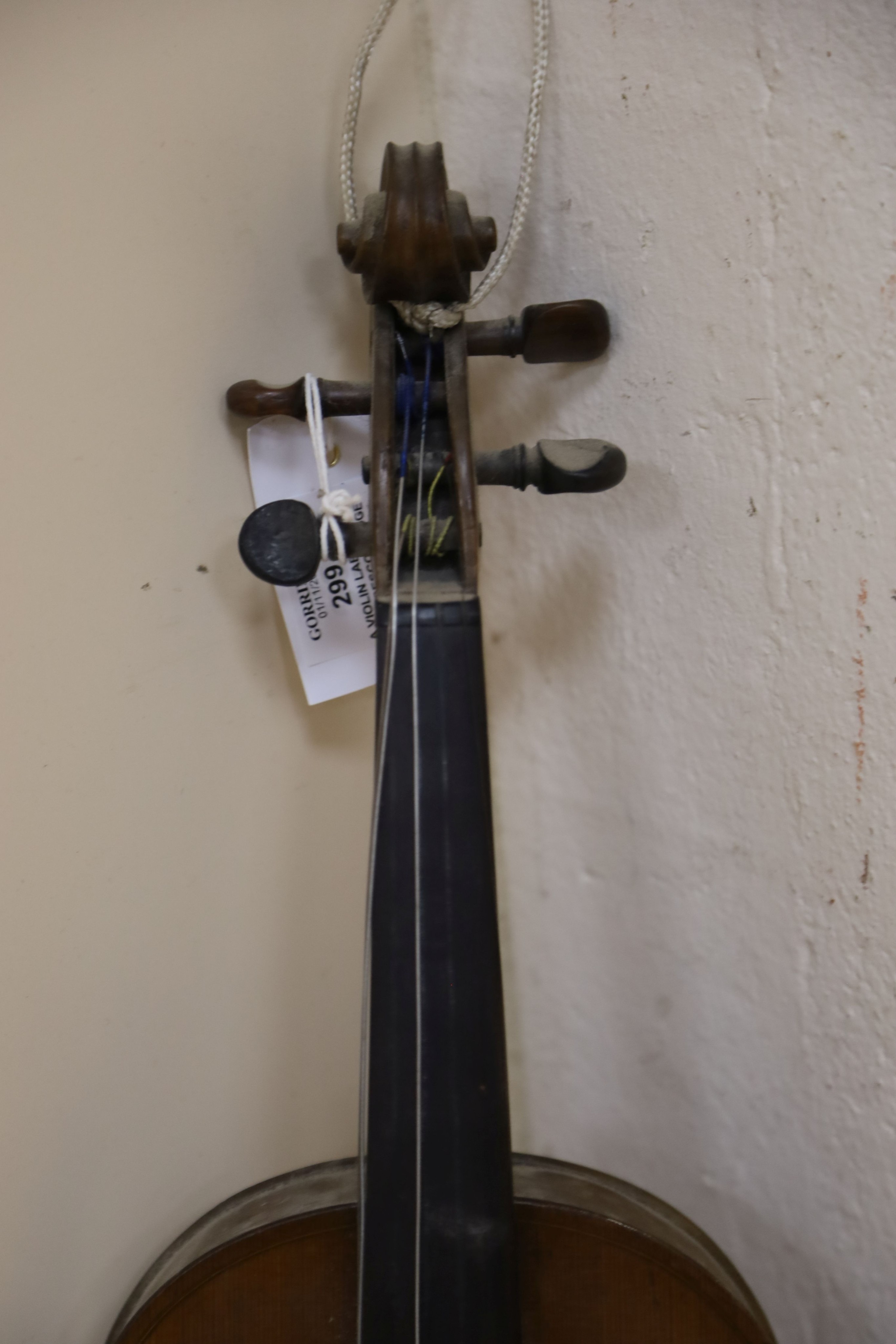 A violin labelled Francesco Ruggeri and a bow. Back of violin excluding button - 36cm